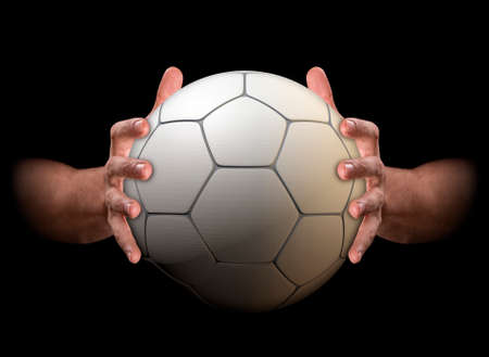 A pair of male hands clamping a soccer ball on an isolated dark background - 3D renderの写真素材