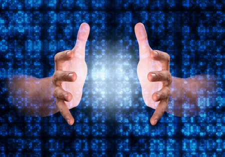 A pair of male hands reaching through digital numerical data figures grasping at something in the...