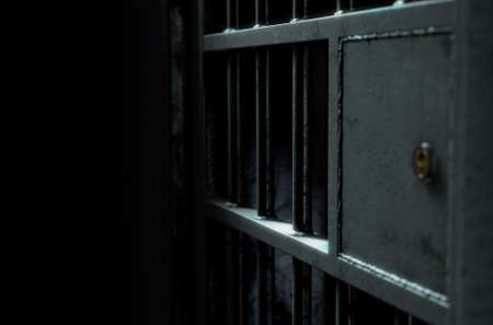 A closeup of a dimly lit prison holding cell door - 3D renderの写真素材