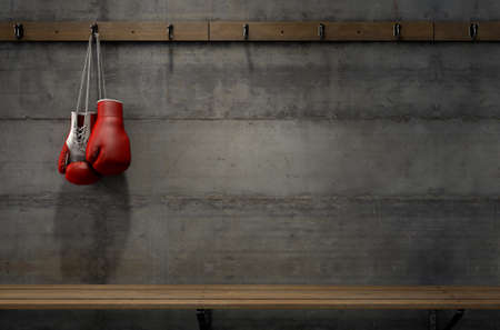Spotlit boxing gloves hanging on a hanger above an empty wooden bench in a locker change room - 3D renderの写真素材