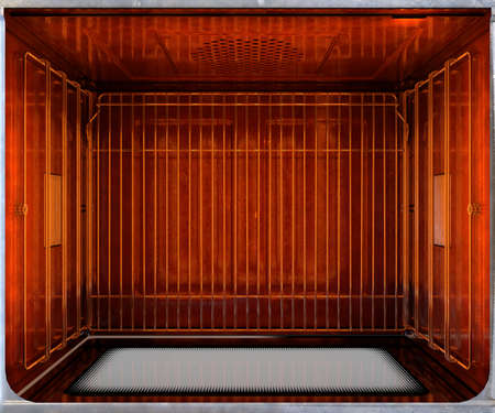A cross section birds-eye view of the inside of an empty hot operational household oven with a...
