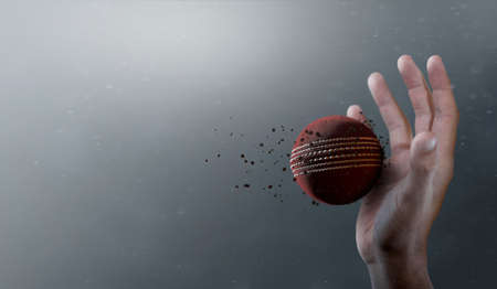 A closeup of a red cricket ball caught in slow motion flying through the air about to be caught by a dirty hand  - 3D renderの写真素材