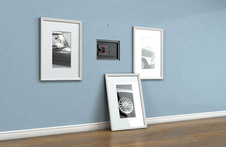 A closed hidden wall safe revealed behind a hanging framed picture on a flat blue wall in a house...