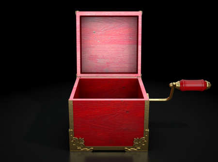 An empty antique open  jack-in-the-box mad of red wood and gold trimmings on a dark studio...
