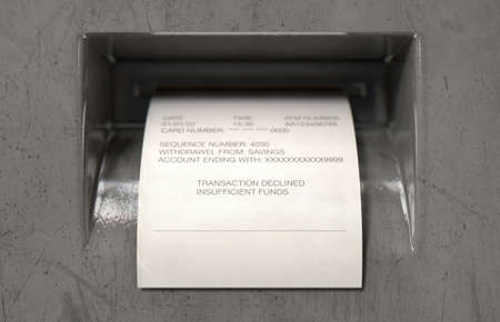 A closeup view of the slip printing section of an atm with a receipt indicating declined transaction for insufficient funds - 3D renderの写真素材