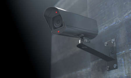 A wireless surveillance camera with illuminated lights mounted on a wall in the night-time with copy...