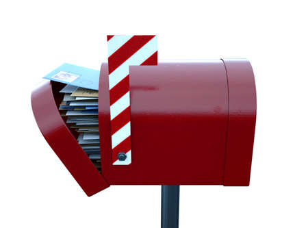 A christmas concept depicting a red retro mailbox belonging to santa clause crammed full of childrens wish list letters to him on an isolated white background - 3D renderの写真素材