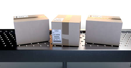 A regular roller ball conveyor system transporting good packaged in generically tracked cardboard...