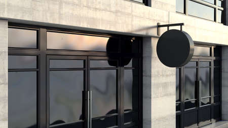 A round black sign mounted outside a generic unbranded shop facade on the high street in the daytime...