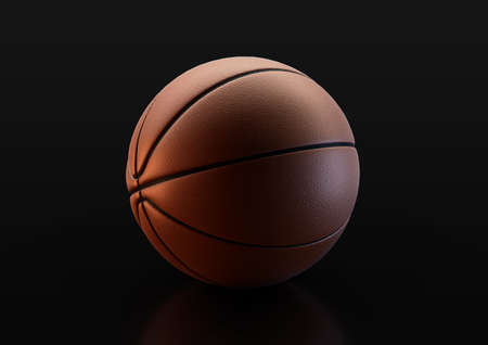 A regulation orange and black rubber basketball in dramatic lighting on an isolated black studio background - 3D renderの写真素材