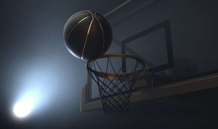 An action shot of a black and gold basketball teetering on the rim of a regular basketball hoop dramatically spotlit from behind on an isolated dark background - 3D renderの写真素材