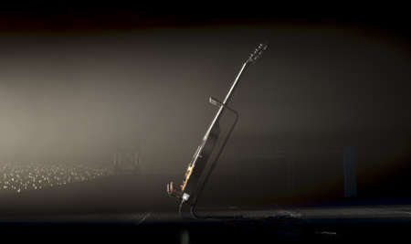 An electric guitar resting on a stand on a music concert stage lit by a single dramatic spotlight facing an audience of illuminated lighter flames - 3D renderの写真素材