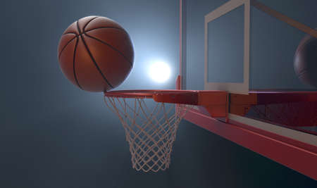An action shot of a regular basketball teetering on the rim of a red basketball hoop dramatically spotlit from behind on an isolated dark background - 3D renderの写真素材