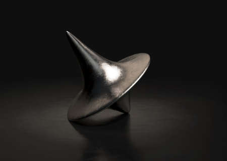 A slightly scratched die-cast lead spinning top in a resting position on a dark background - 3D...