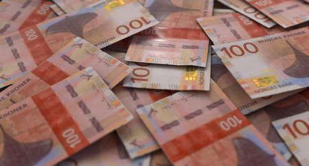 A close-up view of a scattered pile of norwegian kroner banknotes - 3D renderの写真素材