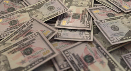 A close-up view of a scattered pile of US dollar banknotes - 3D render