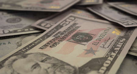 A close-up view of a scattered pile of US dollar banknotes - 3D render