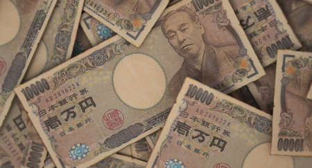 A close-up view of a scattered pile of japanese yen banknotes - 3D renderの写真素材