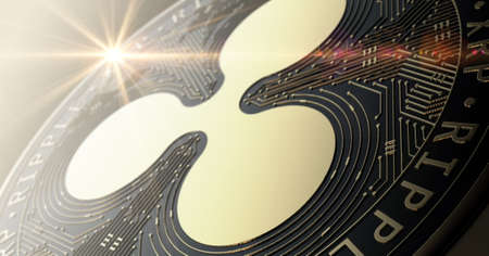 A closeup of a physical ripple bitcoin cryptocurrency in gold and silver coin form on a dark studio background- 3D renderの写真素材