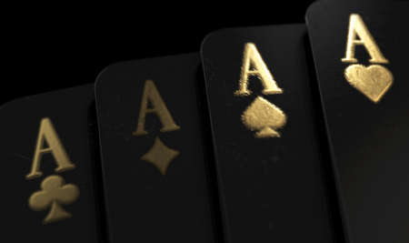 A fanned out suit of four black casino aces playing cards with gold markings on a dark classy...