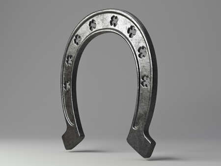 A metal horseshoe with punched out shamrock shapes on an isolated background - 3D renderの写真素材