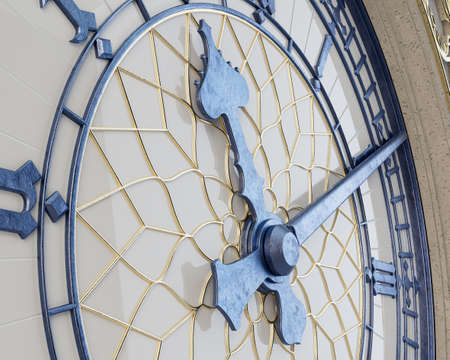 An ornate concept antique tower clock made of a concrete, gold and iron with a white glass backing on an isolated studio background - 3D renderの写真素材