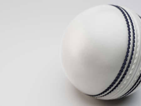 A regular white cricket ball with navy stitching on an isolated background - 3D renderの写真素材