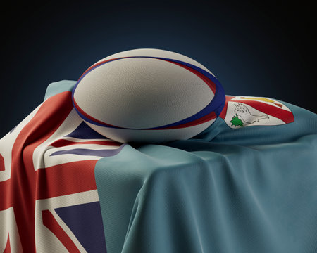 A regular rugby ball resting on a Fiji flag draped over a plinth on an isolated studio background - 3D renderの写真素材