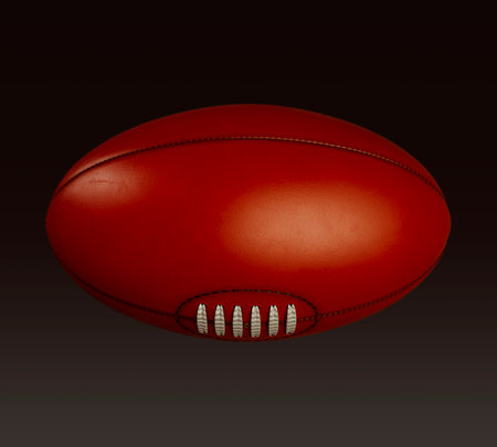 A generic unbranded aussie rules football ball on an isolated dark studio background - 3D renderの写真素材