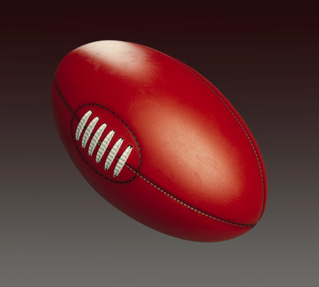 A generic unbranded aussie rules football ball on an isolated dark studio background - 3D renderの写真素材