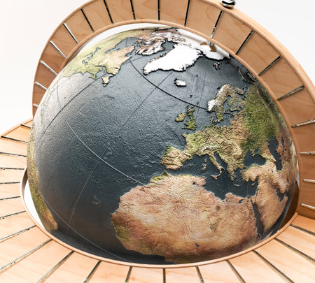 A wooden world globe ornament with silver detail on an isolated white background - 3D renderの写真素材