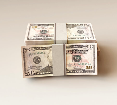 A stack of bundled US dollar banknotes on an isolated light background - 3D renderの写真素材