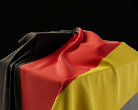 A germany flag draped over a stone plinth on an isolated dark studio background - 3D renderの写真素材