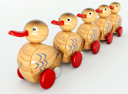 A row of organised wheeled wooden toy ducks with painted markings on an isolated background - 3D renderの写真素材