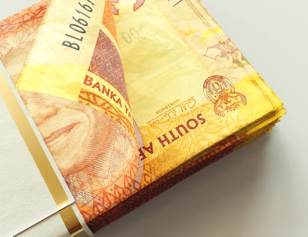 A bundled wad of South Africa Rand banknotes on an isolated light background - 3D render