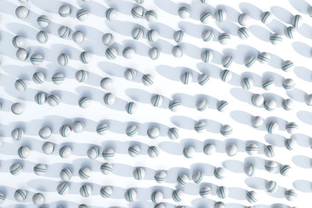 A large array of randomly spaced white generic cricket sports balls create a clear circular area in...