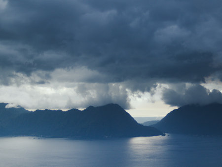 Mountains in the background of the sea and sky with clouds.の写真素材