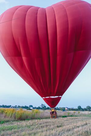 A red balloon in the shape of a heart. The biggest Valentineの写真素材