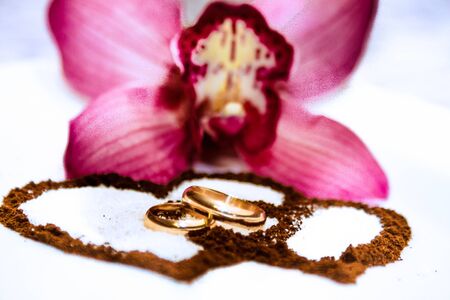 Wedding rings, tender orchids and coffee hearts.のeditorial素材