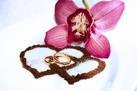 Wedding rings, tender orchids and coffee hearts.のeditorial素材