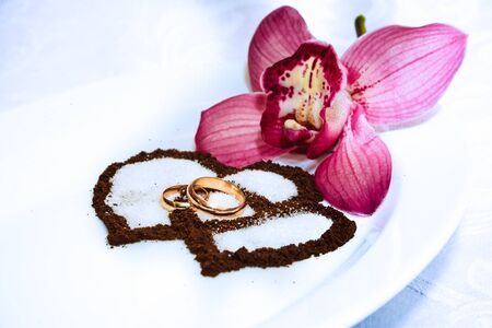 Wedding rings, tender orchids and coffee hearts.のeditorial素材