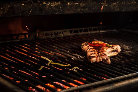 Sef roasts grilled meat. Close-up.
