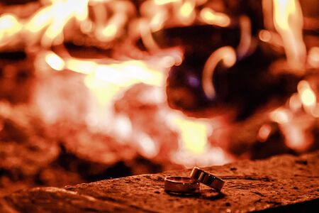 Wedding rings against the background of fire.の写真素材
