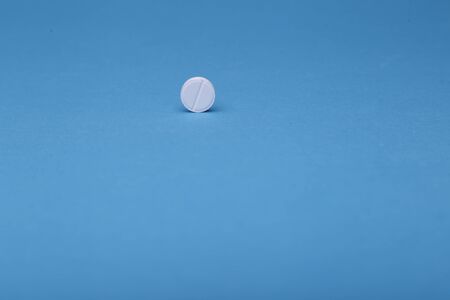 White pills on a blue background