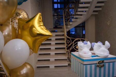 White children's booties in a gift boxの写真素材