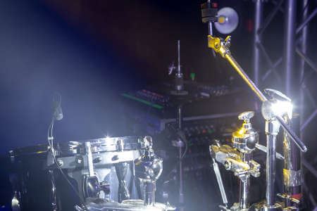 Drums and drum set. Beautiful blue and red background, with rays of light. Beautiful special effects of smoke and lighting. Musical instrument. The concept of music. Close-up photo.の写真素材