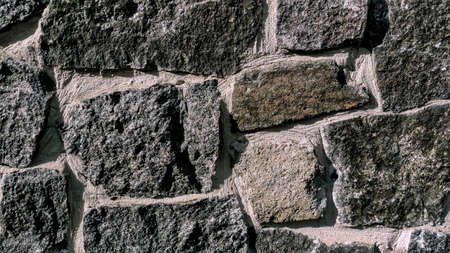 Gray stone wall. Stone masonry.