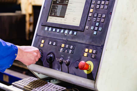 worker working with cnc machine at workshop