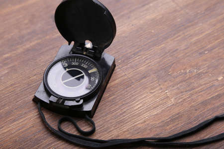 Compass on brown wooden table backgroundの写真素材