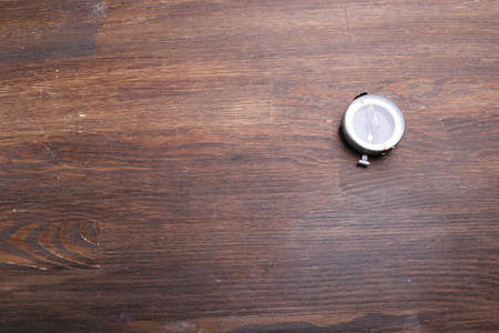 Compass on brown wooden table backgroundの写真素材